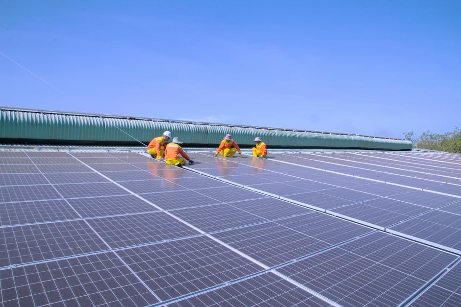 Workers installing solar panels on a sunny rooftop, emphasizing renewable energy and sustainability.