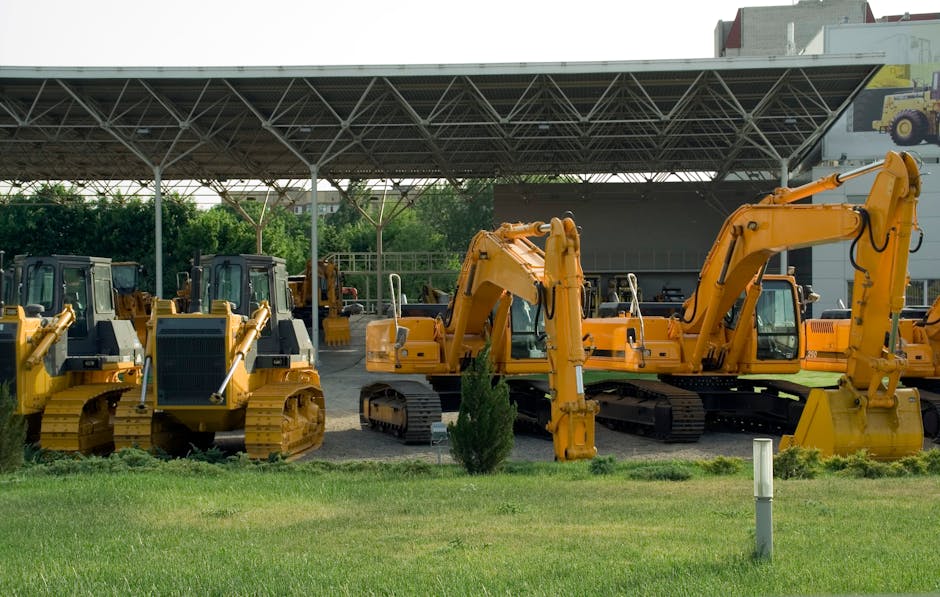 Heavy-duty construction machinery displayed outdoors, include excavators and bulldozers.